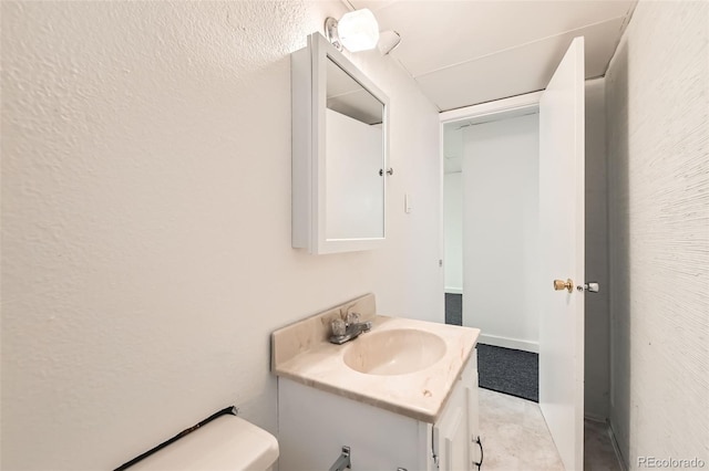 5556 Vaughn St, Denver, CO 80239 - bathroom with vanity and a textured wall