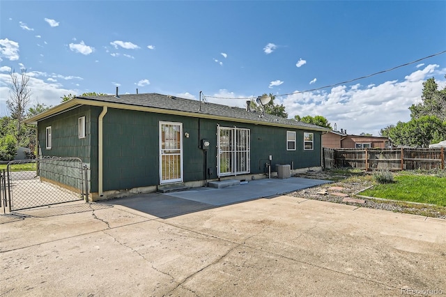 5556 Vaughn St, Denver, CO 80239 - rear view of house with a patio area and a gate