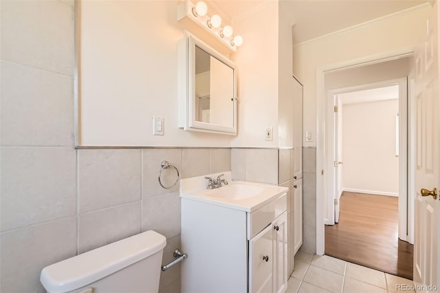 5556 Vaughn St, Denver, CO 80239 - bathroom with tile walls, vanity, tile patterned flooring, and wainscoting