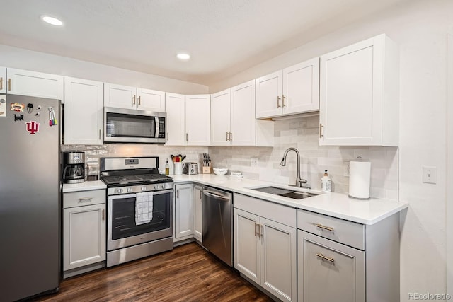 kitchen featuring dark hardwood / wood-style flooring, white cabinetry, and appliances with stainless steel finishes