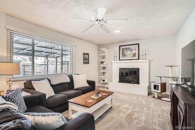 carpeted living room with a fireplace, a textured ceiling, and ceiling fan