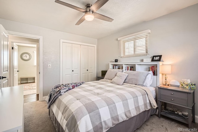 carpeted bedroom featuring ceiling fan and a closet