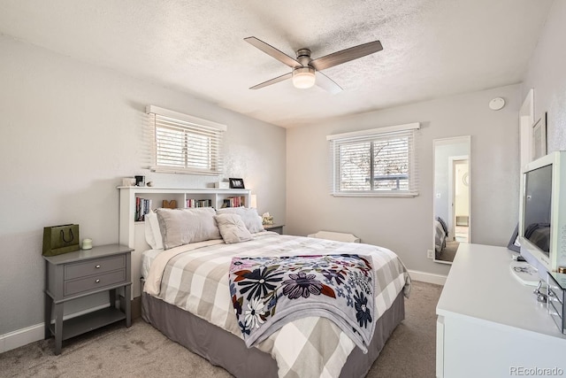 bedroom featuring multiple windows, light colored carpet, and ceiling fan