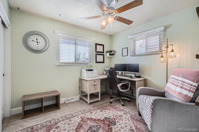 carpeted home office with ceiling fan