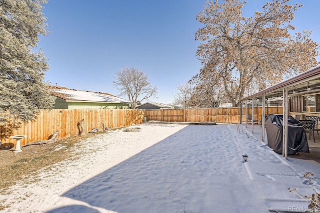 view of yard layered in snow