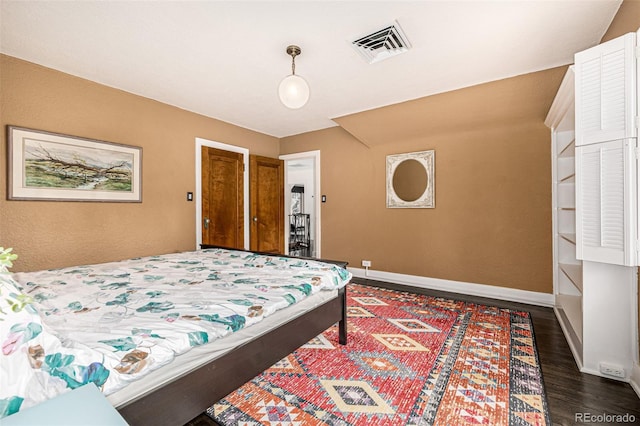 1795 N Monaco St Parkway, Denver, CO 80224 - bedroom featuring dark wood finished floors and baseboards