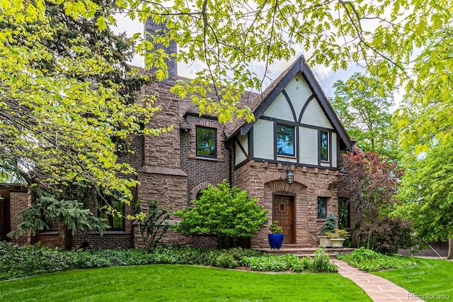 1795 N Monaco St Parkway, Denver, CO 80224 - english style home with stucco siding, a front lawn, and stone siding