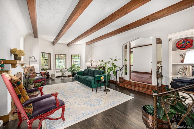 1795 N Monaco St Parkway, Denver, CO 80224 - living area with arched walkways, beam ceiling, and wood finished floors
