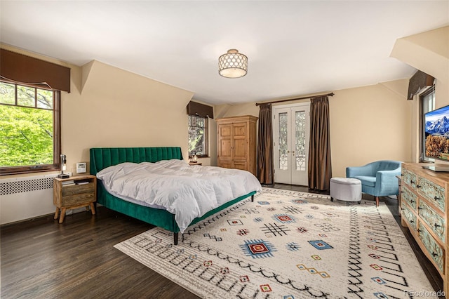 1795 N Monaco St Parkway, Denver, CO 80224 - bedroom with wood finished floors, radiator, and access to outside
