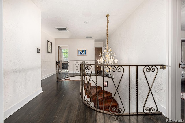 1795 N Monaco St Parkway, Denver, CO 80224 - staircase with a chandelier, wood finished floors, baseboards, a textured wall, and a textured ceiling