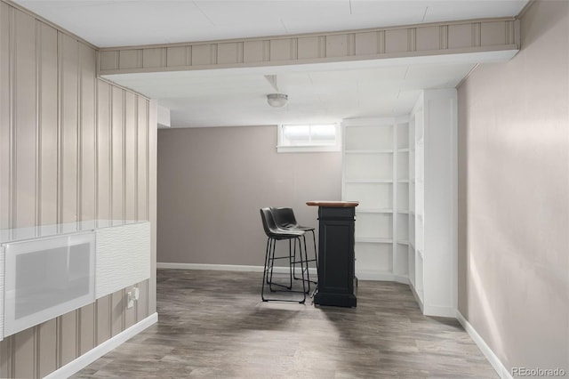 interior space featuring baseboards and wood finished floors