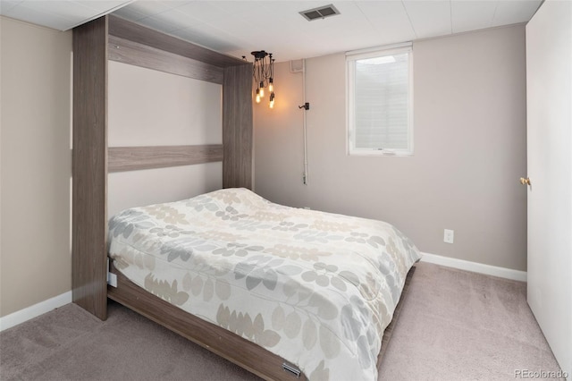 carpeted bedroom featuring visible vents and baseboards