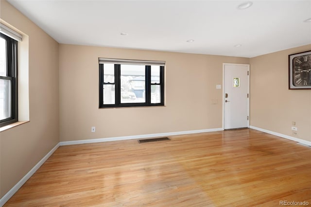 unfurnished room with visible vents, recessed lighting, light wood-style floors, and baseboards