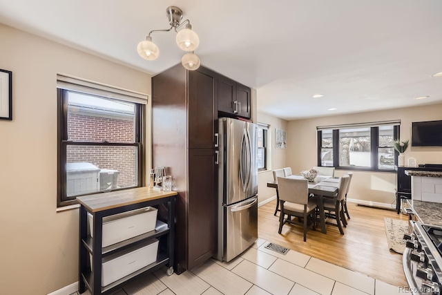424 S Leyden St, Denver, CO 80224 - kitchen with stainless steel appliances, plenty of natural light, dark brown cabinets, baseboards, and recessed lighting