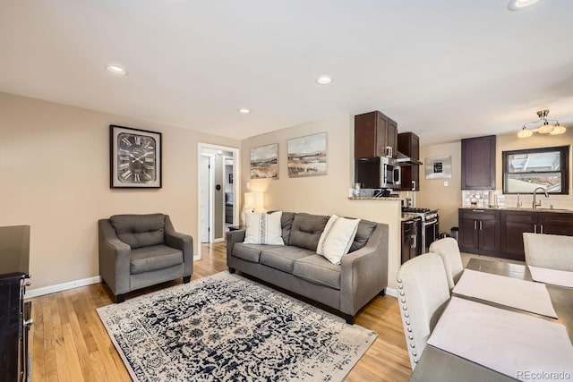 424 S Leyden St, Denver, CO 80224 - living room featuring light wood-style flooring, recessed lighting, and baseboards