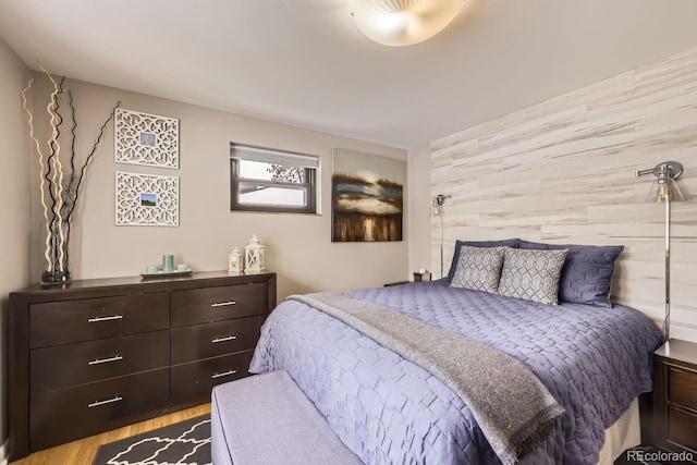 424 S Leyden St, Denver, CO 80224 - bedroom featuring an accent wall and wood finished floors