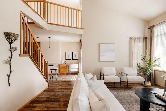 1157 Belleview Dr, Fort Collins, CO 80526 - living area featuring stairway, plenty of natural light, dark wood-style floors, baseboards, and a towering ceiling