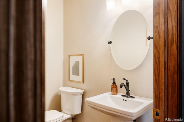 1157 Belleview Dr, Fort Collins, CO 80526 - half bathroom featuring a sink and toilet