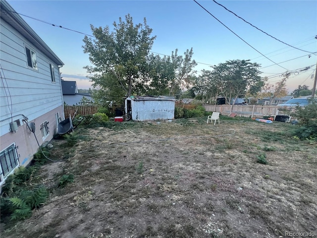 yard at dusk with a storage shed