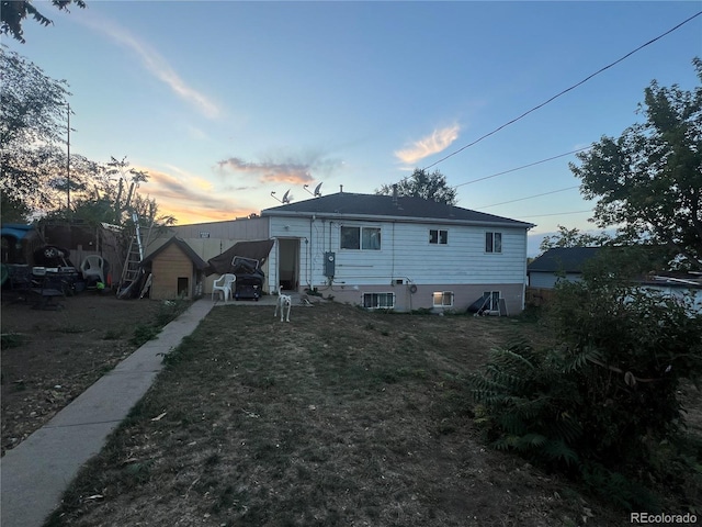 view of back house at dusk