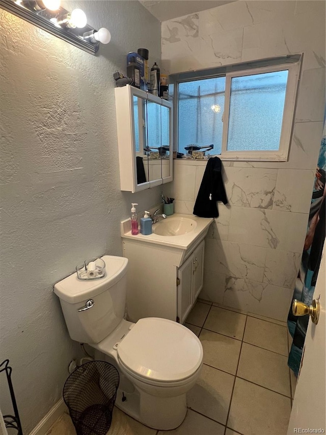 bathroom featuring vanity, a shower with curtain, toilet, and tile patterned floors