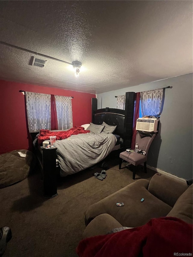 carpeted bedroom featuring a textured ceiling and cooling unit