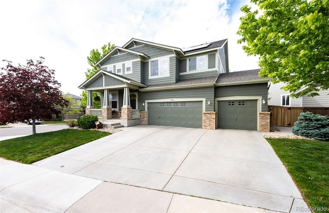 5550 Fox Meadow Ave, Highlands Ranch, CO 80130 - craftsman-style house with a garage, solar panels, driveway, a porch, and brick siding