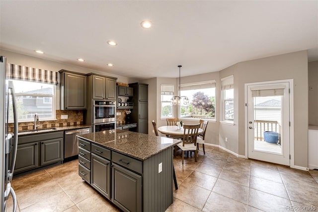 5550 Fox Meadow Ave, Highlands Ranch, CO 80130 - kitchen featuring appliances with stainless steel finishes, healthy amount of natural light, gray cabinets, a sink, and recessed lighting