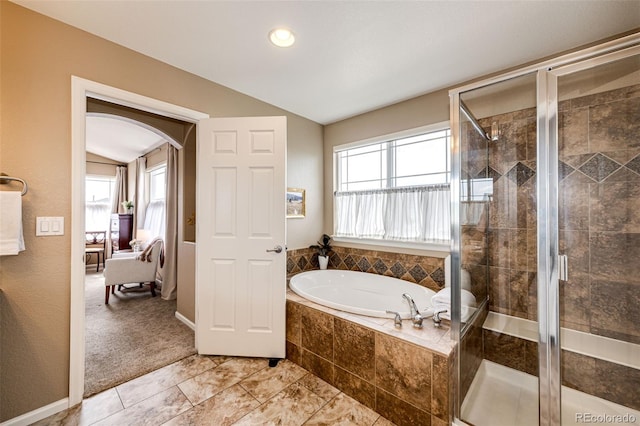 5550 Fox Meadow Ave, Highlands Ranch, CO 80130 - ensuite bathroom featuring healthy amount of natural light, a bath, vaulted ceiling, and a stall shower