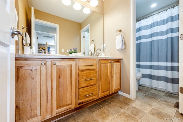 5550 Fox Meadow Ave, Highlands Ranch, CO 80130 - full bathroom with toilet, double vanity, and baseboards