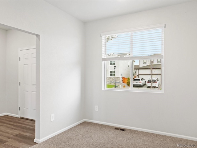 unfurnished room with baseboards