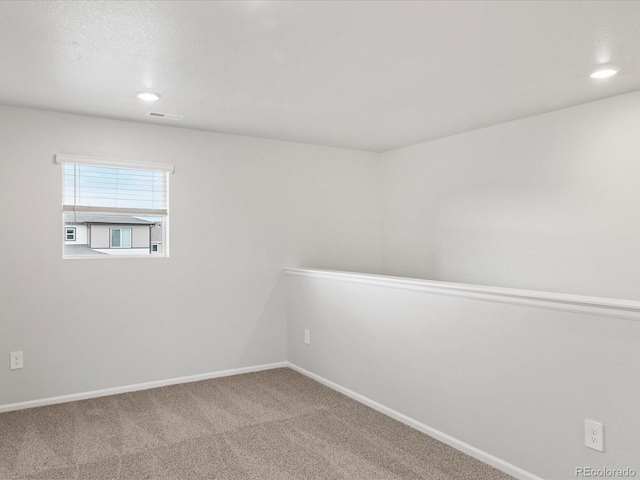 carpeted spare room with baseboards and recessed lighting