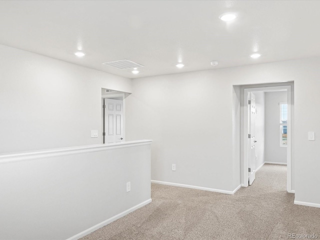 spare room with recessed lighting, baseboards, and carpet
