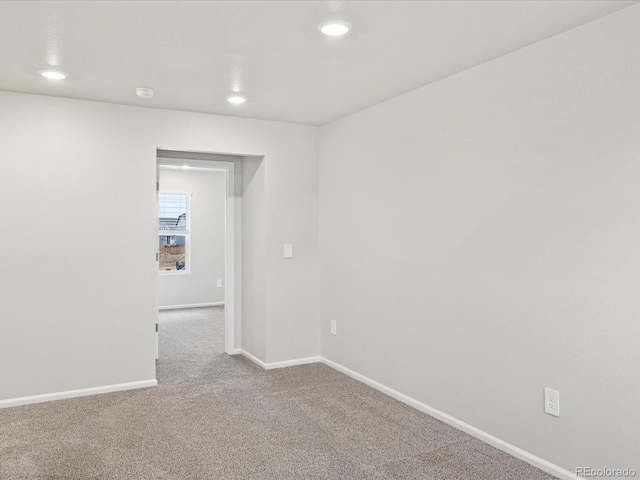 unfurnished room featuring carpet flooring, baseboards, recessed lighting, and a smoke detector