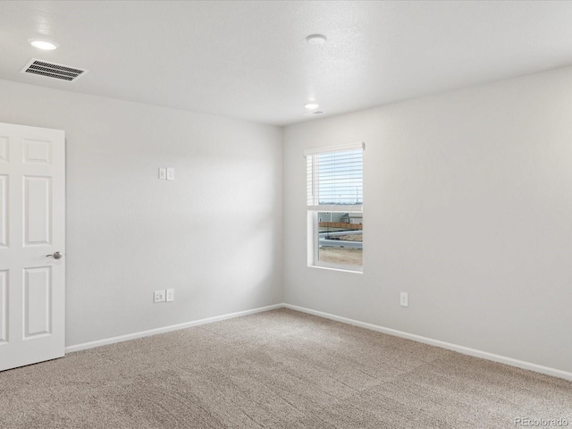 carpeted empty room with baseboards