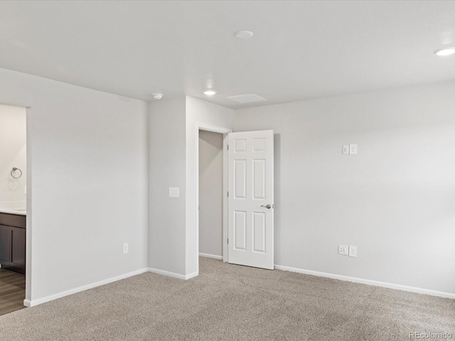 unfurnished bedroom featuring carpet, baseboards, recessed lighting, and connected bathroom