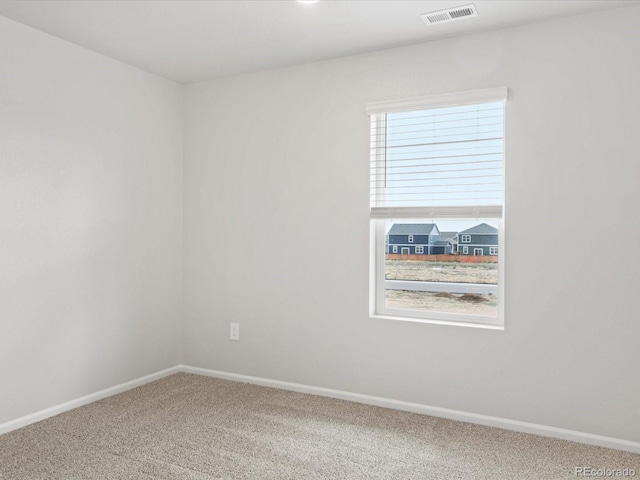 carpeted spare room with baseboards