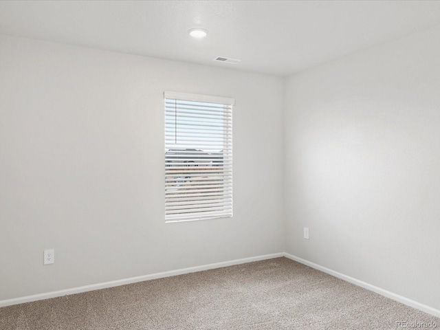 spare room featuring carpet, baseboards, and recessed lighting