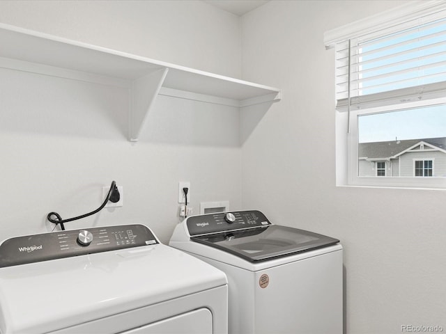 clothes washing area with washer and dryer