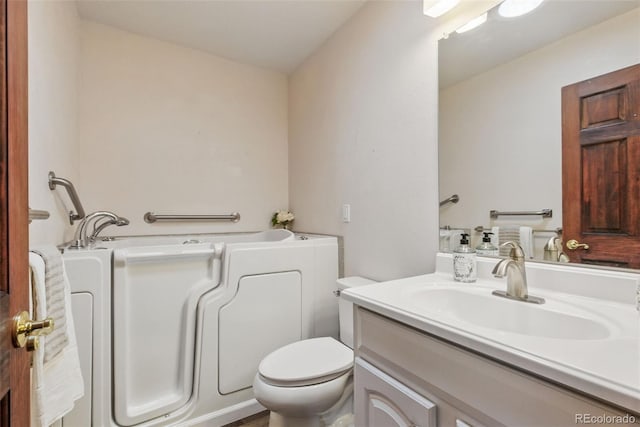 full bath with toilet, a bath, and vanity