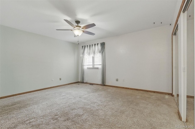 unfurnished bedroom featuring light carpet, baseboards, and ceiling fan