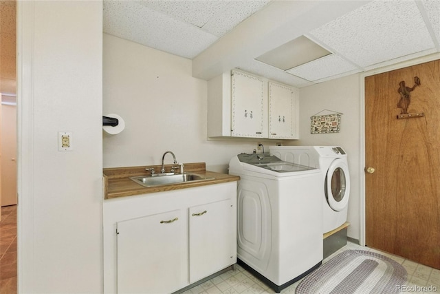 laundry room with independent washer and dryer, cabinet space, and light flooring