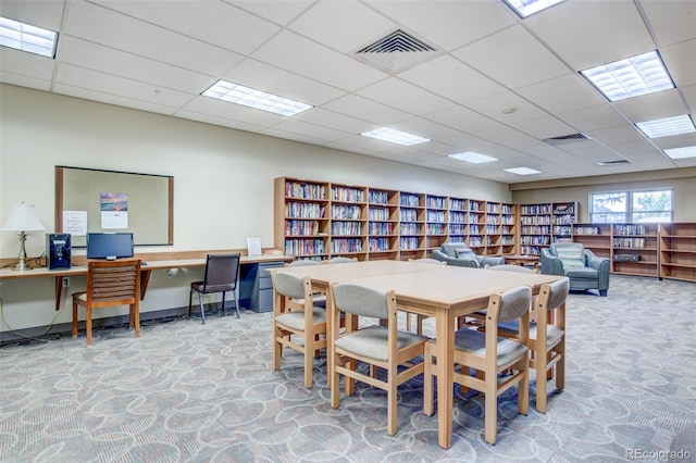 office area with carpet flooring and a drop ceiling