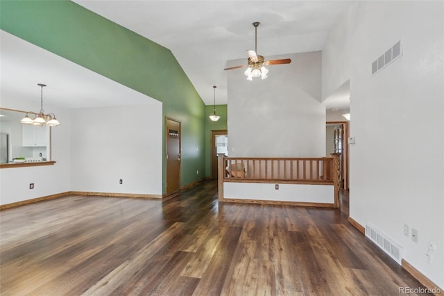 unfurnished living room featuring high vaulted ceiling, a ceiling fan, wood finished floors, baseboards, and a chandelier