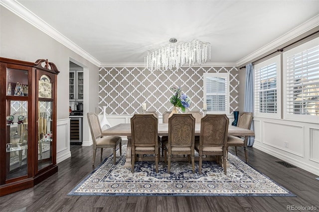 dining room with an inviting chandelier, dark hardwood / wood-style flooring, crown molding, and wine cooler