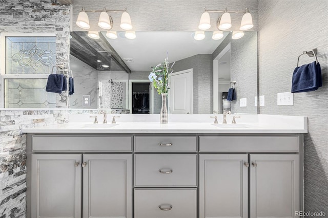 bathroom featuring walk in shower and vanity