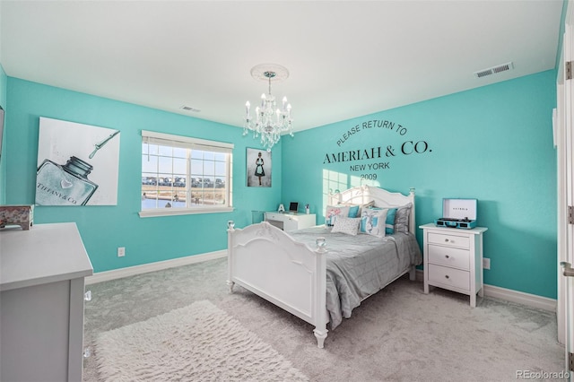 bedroom with light colored carpet and a notable chandelier