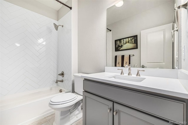 full bathroom with tile patterned floors, toilet, vanity, and tiled shower / bath