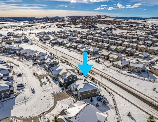 snowy aerial view featuring a mountain view