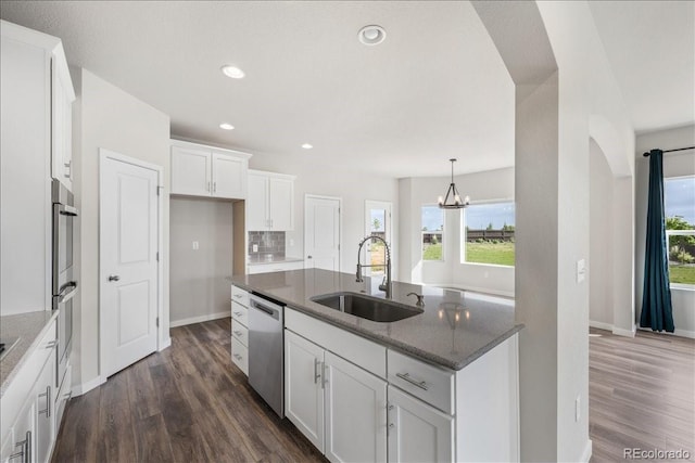 1711 Lazear St, Loveland, CO 80538 - kitchen featuring dishwasher, a sink, dark wood-style flooring, white cabinetry, and recessed lighting